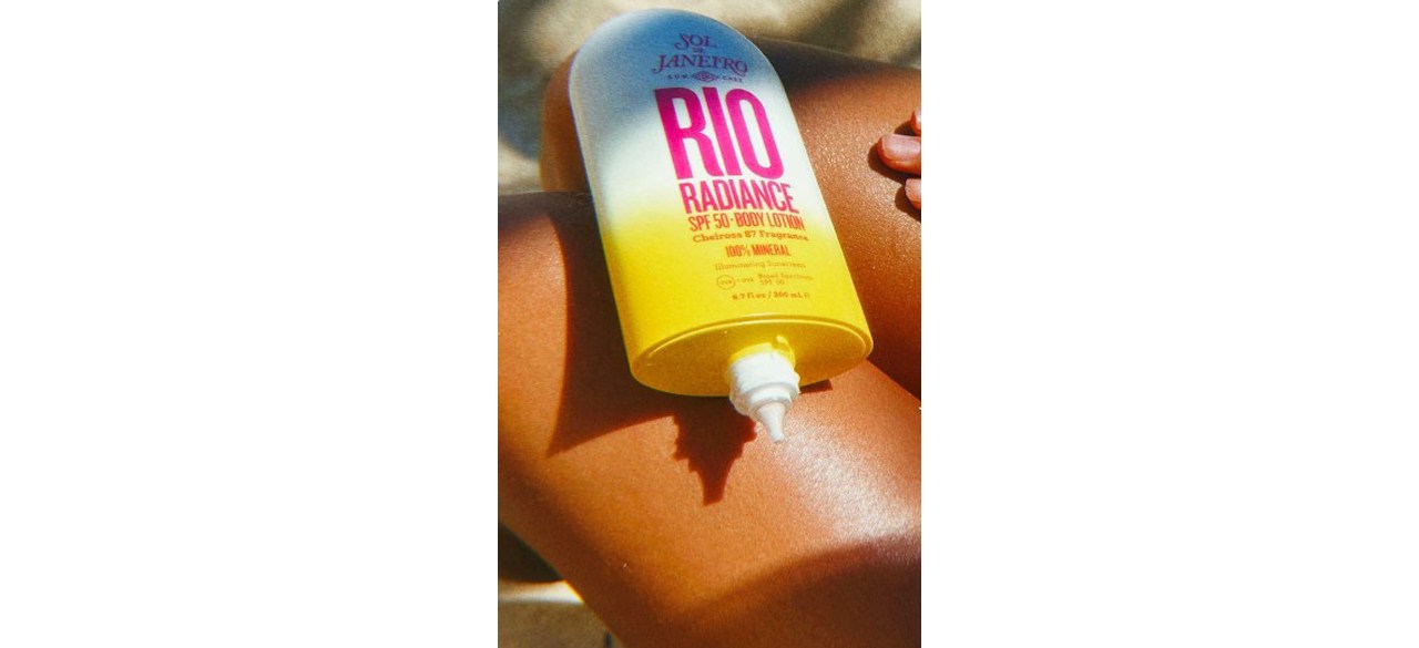 Bottle ofRio Radiance SPF 50 Body Lotion on tanned leg