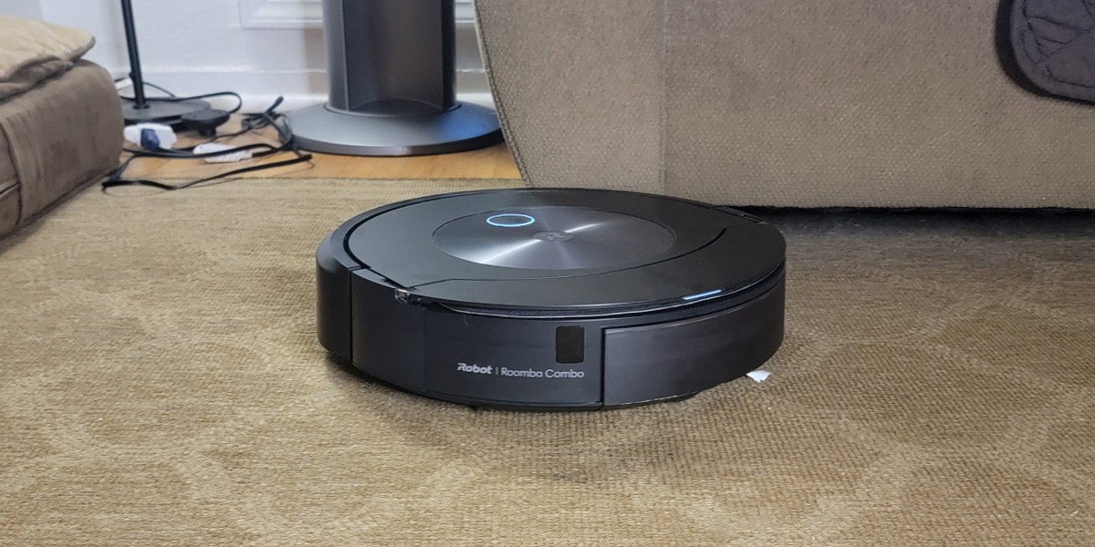 Roomba j7+ on carpet near furniture