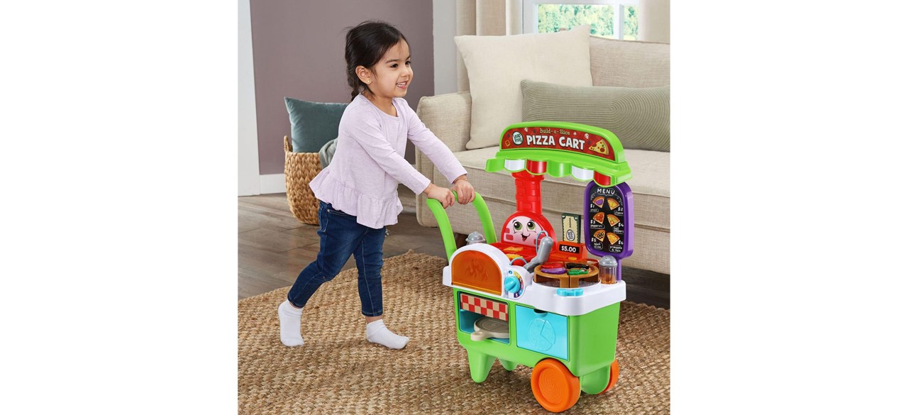 Child playing with Leapfrog Build-A-Slice Pizza Cart