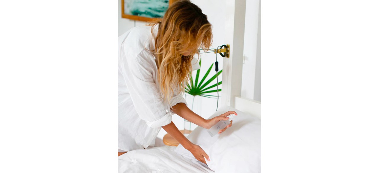 person spraying Baloo Pillow Mist on pillow