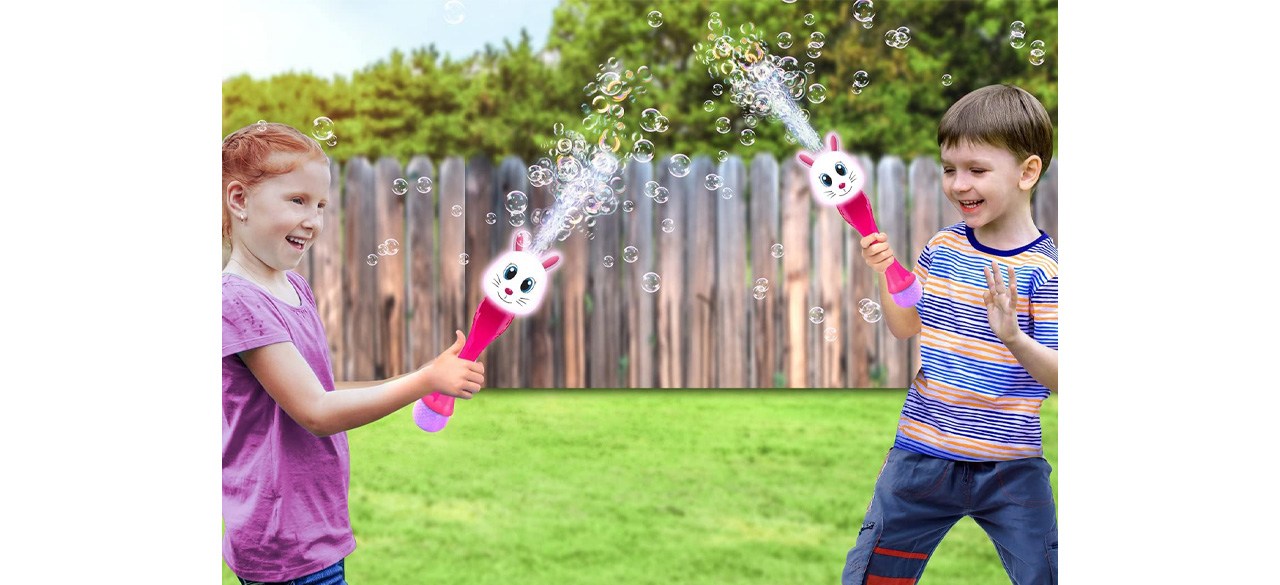  Two children playing with ArtCreativity Light-Up Bunny Bubble Wands in yard