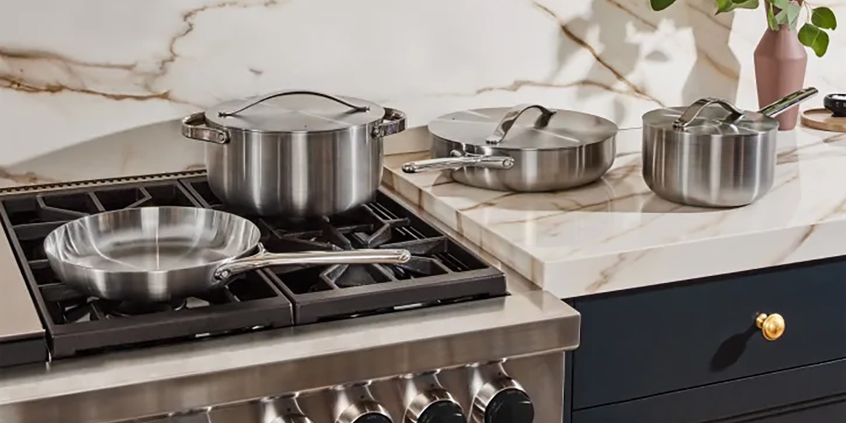 Caraway Stainless Steel Cookware Set displayed on stovetop and kitchen counter