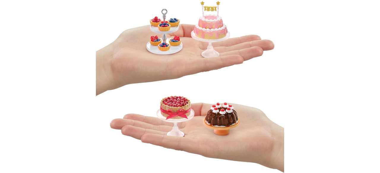 Two hands holding MGA’s Miniverse Make It Mini Food Diner Series Two Pastry Shop Bundle