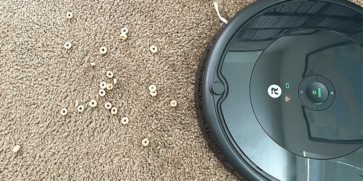 Roomba vacuuming cereal on carpet