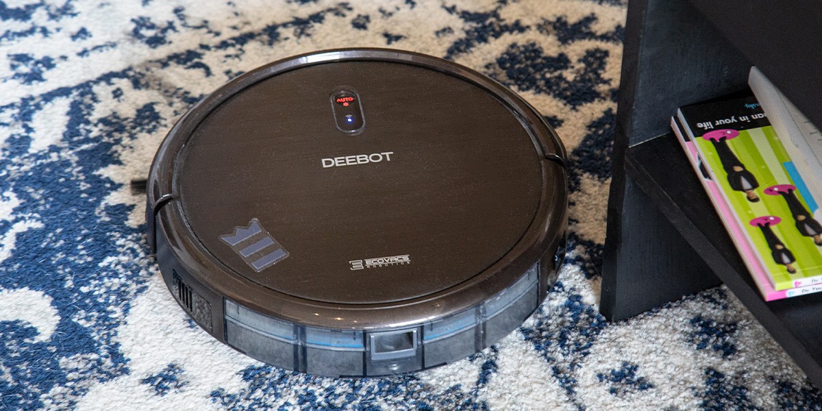 Deebot N8 Pro+ on blue and white on carpeted area. 