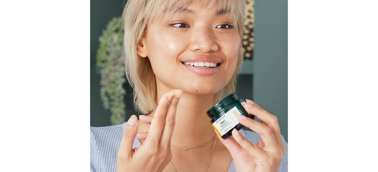 Person applying The Body Shop Vitamin-C Boost Moisturizer