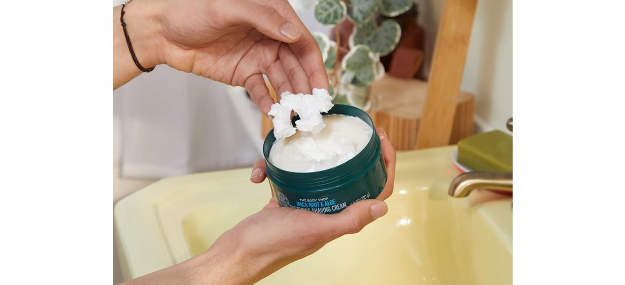 Hand with The Body Shop Maca Root & Aloe Softening Shaving Cream for Men