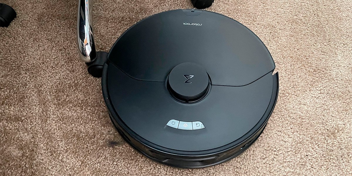 Robot vacuum on tan carpet