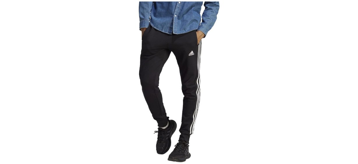 adidas Men's Essentials French Terry Cuffed 3-Stripes Pants on white background adidas Men's Essentials French Terry Cuffed 3-Stripes Pants on white background