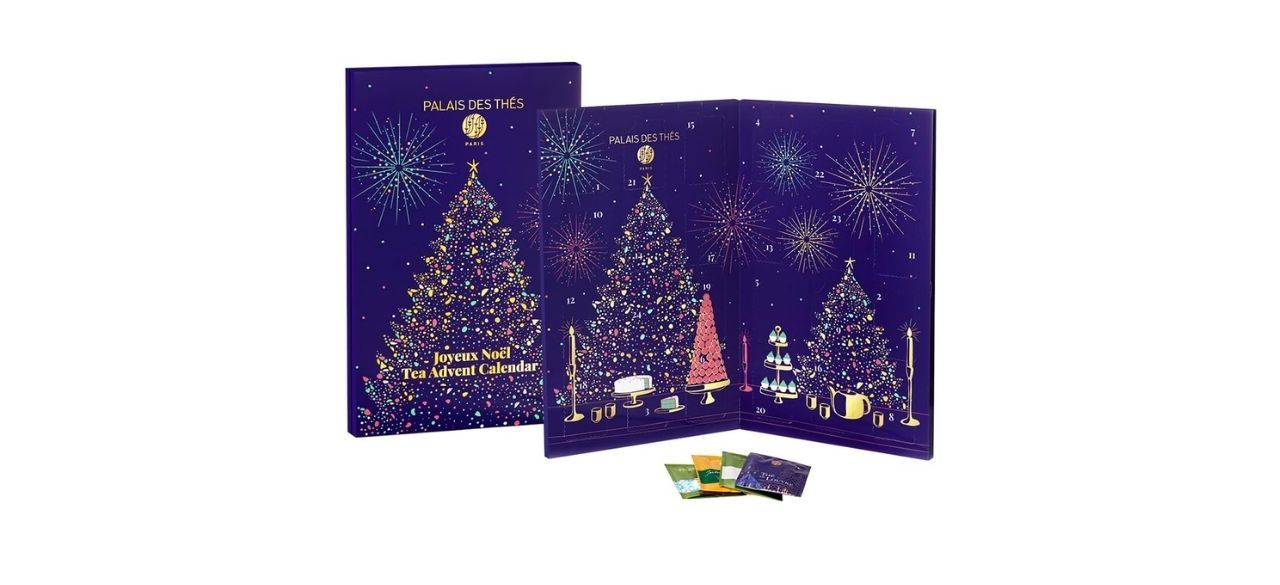 dark blue advent calendar with images of gold Christmas trees, next to some tea bags