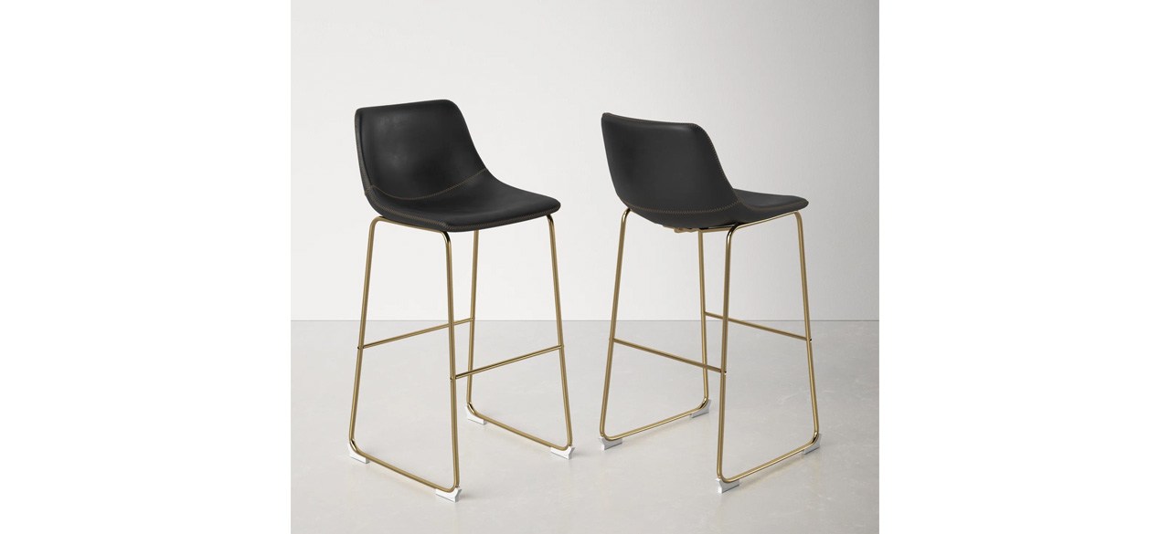 Black and gold AllModern Nia Bar and Counter Stools on gray background