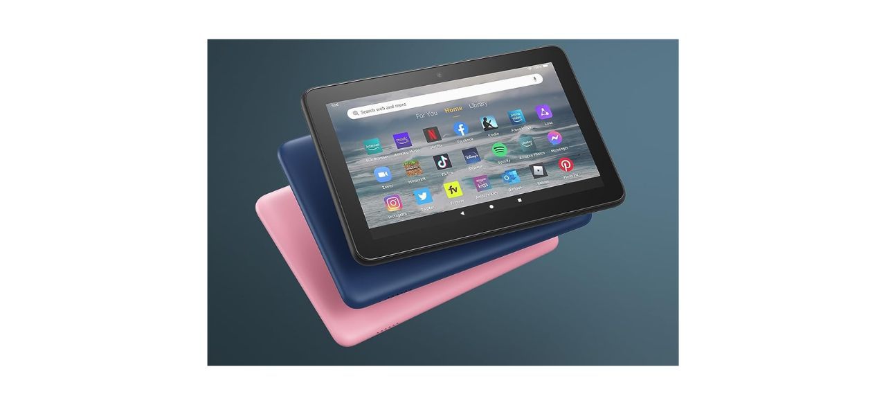 3 Amazon Fire 7 tablets (2022 release) in black, navy blue and pink, showing apps on one of them.