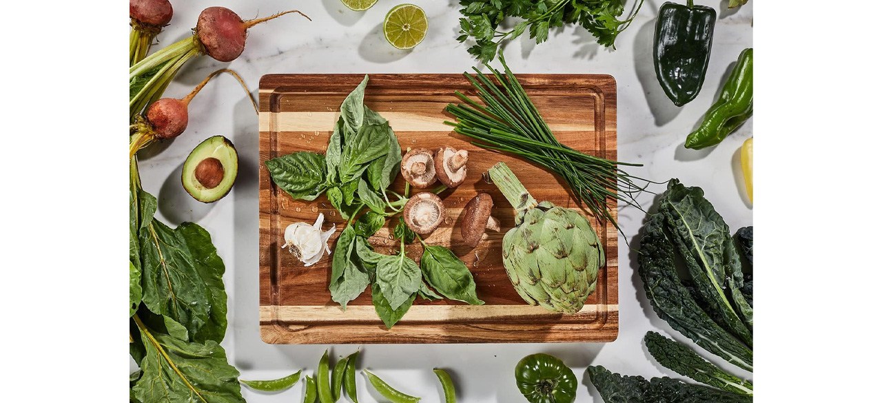Sonder Los Angeles Acacia Wood Cutting Board on counter surrounded by vegetables