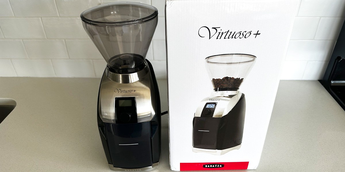 Baratza Virtuoso+ Conical Burr Coffee Grinder next to product packaging on countertop