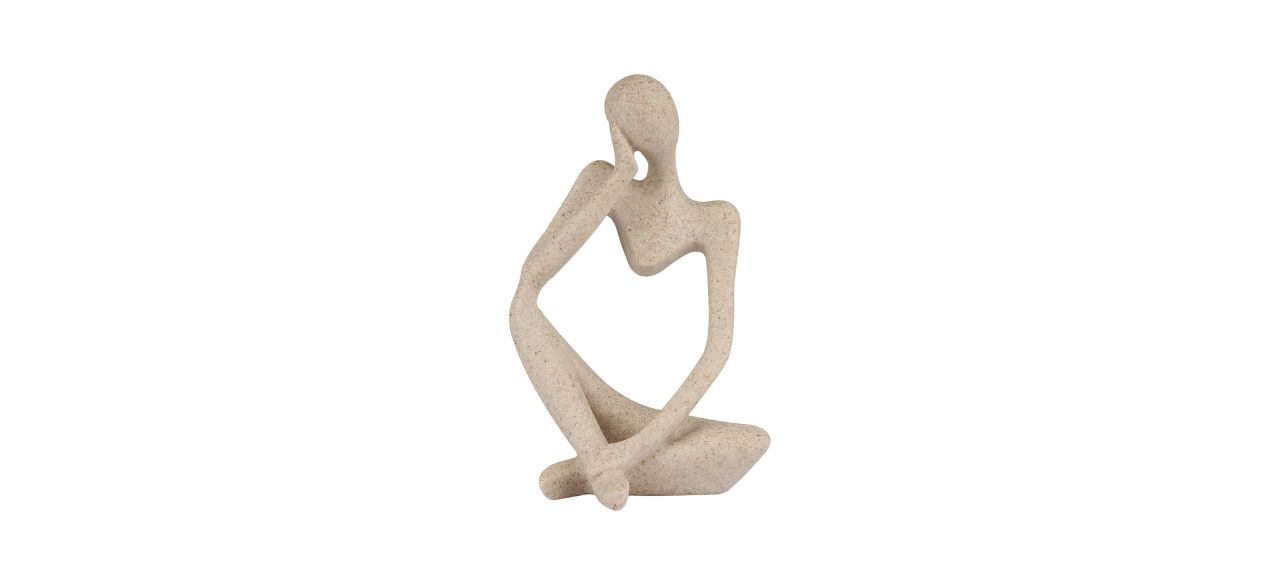 a small statue of a person in a thinking pose