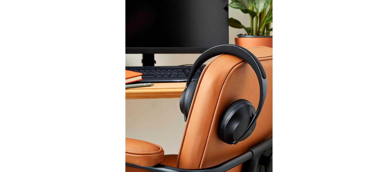 Bose Headphones 700 hanging on back of chair