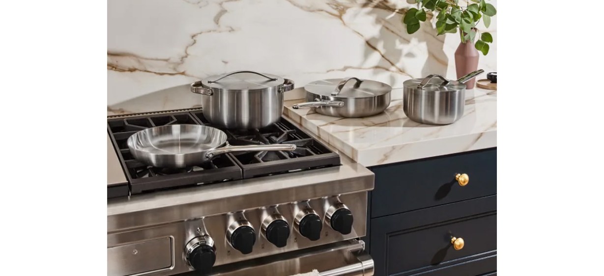 Caraway Stainless Steel Cookware Set on a counter and stove Caraway Stainless Steel Cookware Set on a counter and stove