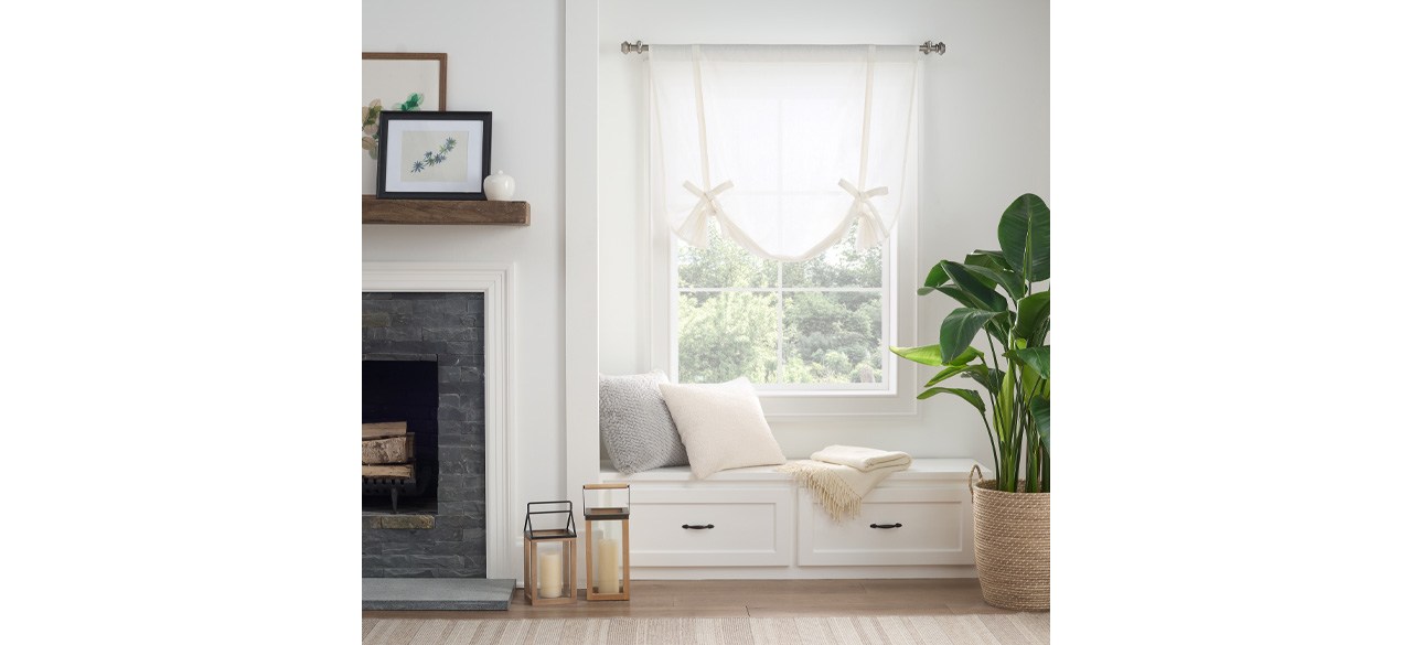 Live Comfortably Mercantile Drop Cloth Tie-Up Shade in sheer white, hanging up in a living room window