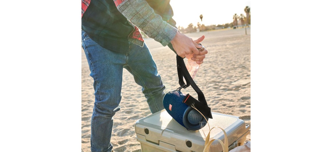 Person using JBL - Xtreme 2 Portable Bluetooth Speaker on beach