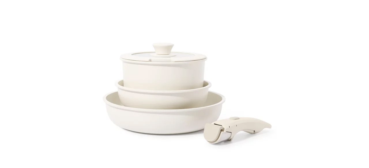 A five-piece white Carote pots and pans set.