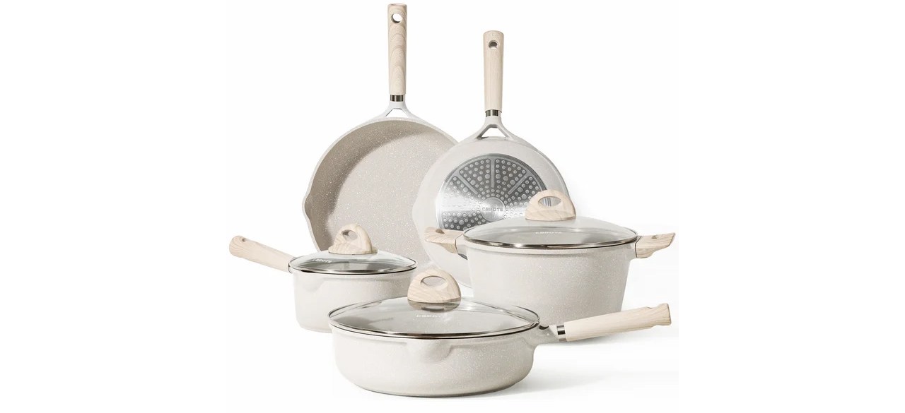 An eight-piece beige Carote pots and pans set.