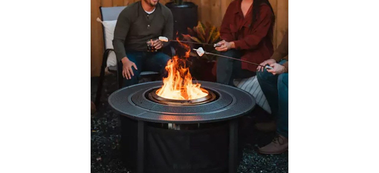 People roasting marshmallows indoors using Solo Stove Surround