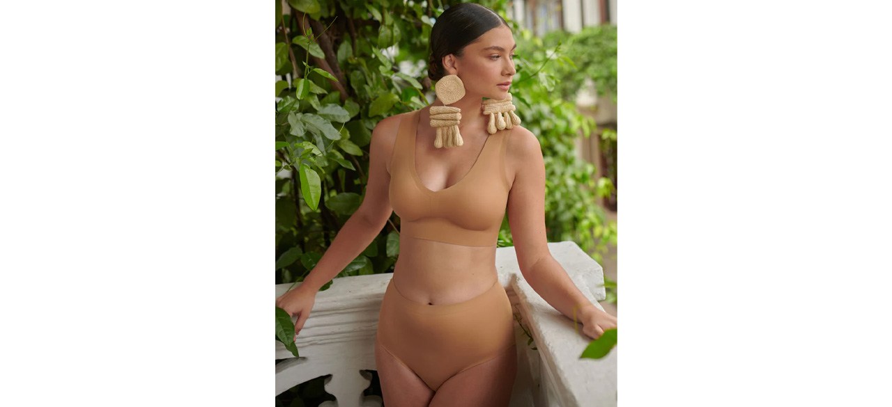 Women wearing tan EBY Seamless Pull-Over Bralette and big tan earrings