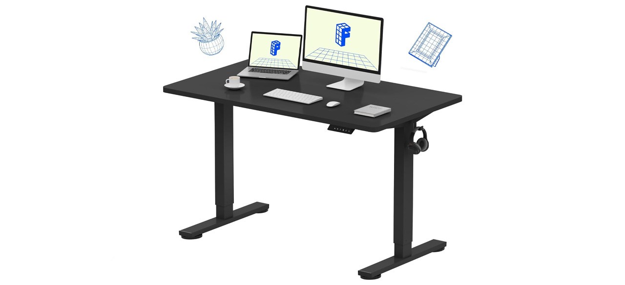 Flexispot Standing Desk with a computer and monitor on it and illustrations of desk lamps above it