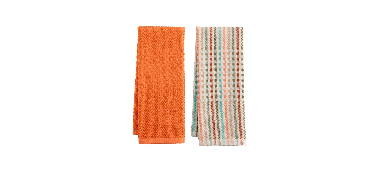 An orange hand towel and a beige hand towel with red, pink, green and orange vertical stripes.