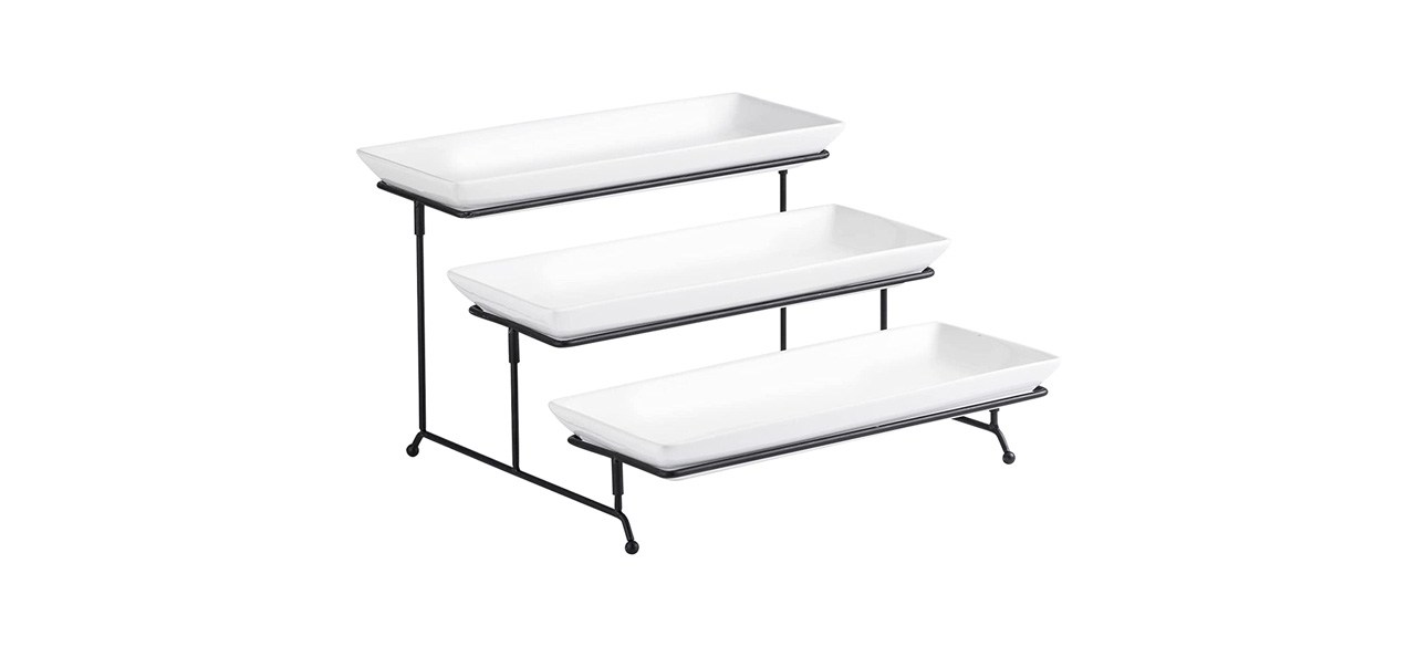 3 rectangle white ceramic serving platters sitting on a 3-tiered black metal stand