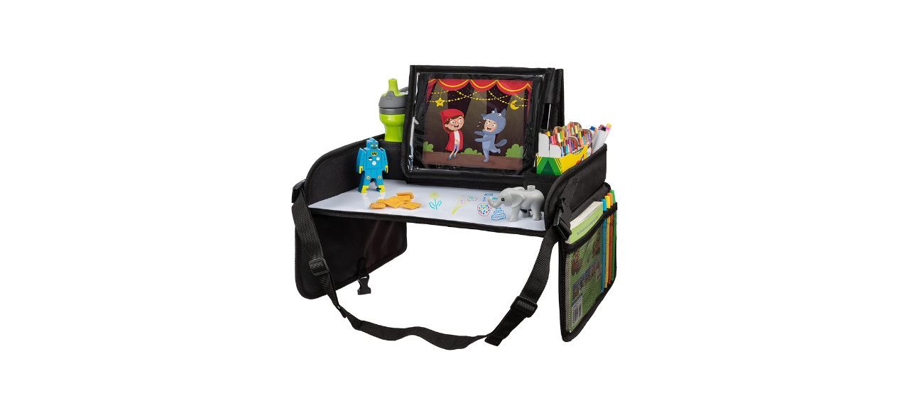 a travel tray that straps on the back of a seat in a car. It has an iPad and some toys on it. There are mesh pockets on either side of it. The desk/table portion is also a whiteboard.