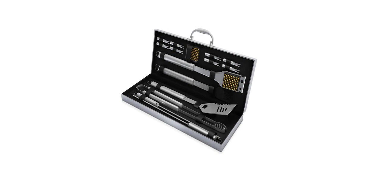 A metal case with grilling tools inside. Tools include: a Spatula with a Bottle Opener, metal tongs, 2 skewers, a Wire Cleaning Brush, 1 Extra Cleaning Brush Head, 8 Corn Holders and a Basting Brush