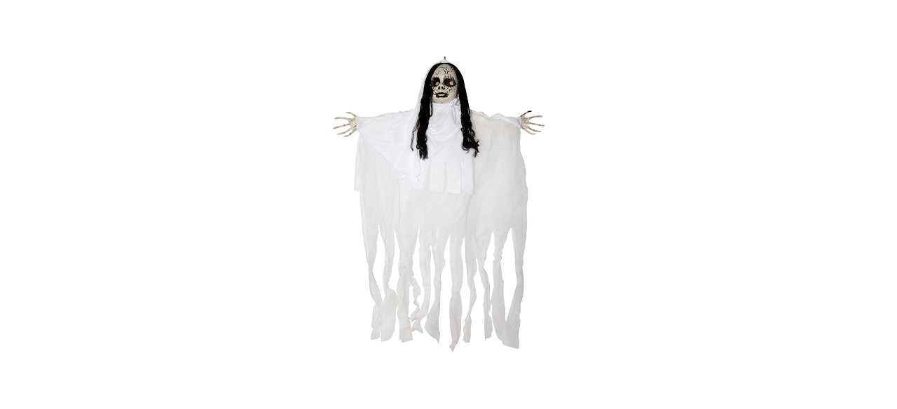 A hanging ghost decoration with a white ghoulish face and long black hair