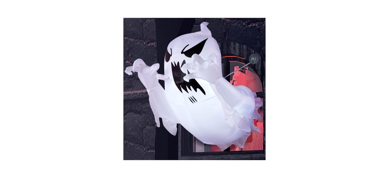 An inflatable ghost that looks like it's flying out of a broken window