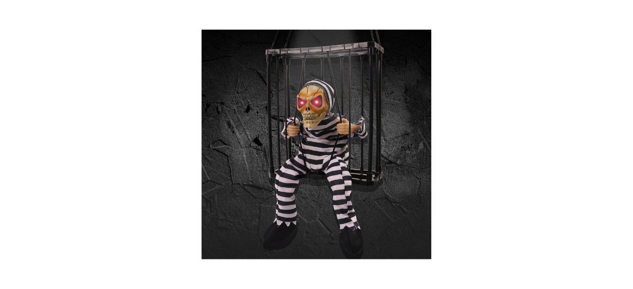 A hanging cage with a skeleton that has glowing red eyes and is dressed in a striped jail uniform. The skeleton is trying to pull the bars of the cage apart. 