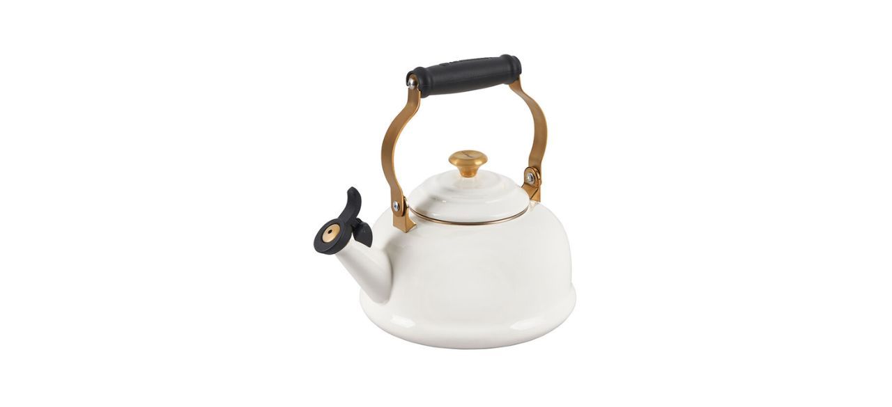 white tea kettle with gold and black handle