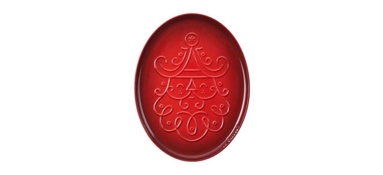 red serving platter with engraving of Santa Claus' face