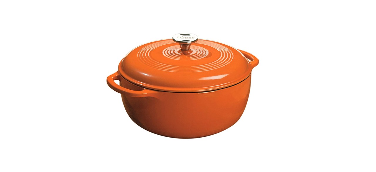 An orange enameled round cast-iron Dutch oven with 2 handles on the side and a lid that has a knob on it.