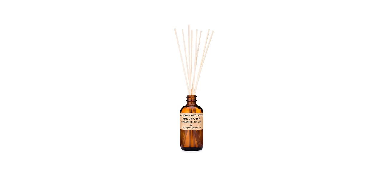 an amber bottle with reed diffusers in it