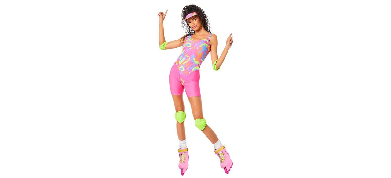 A woman dressed in a skating costume with knee pads