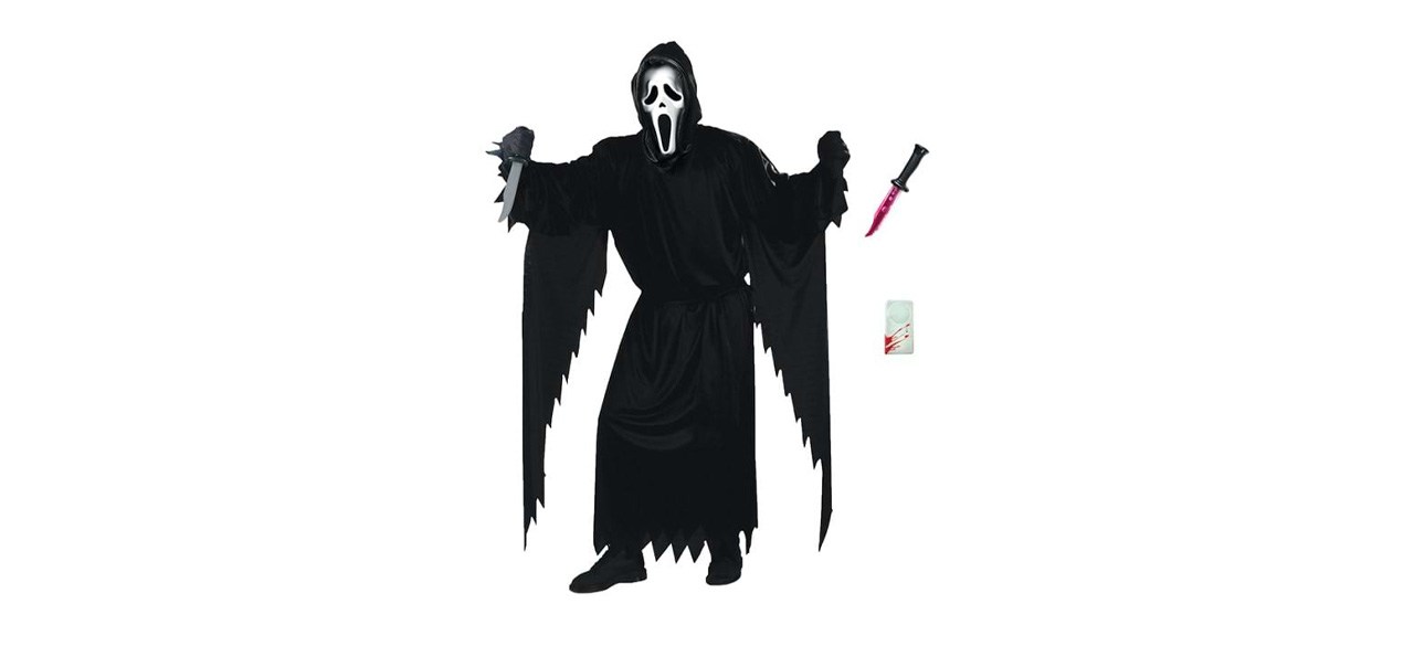 An adult dressed in a Ghost Face costume holding a knife