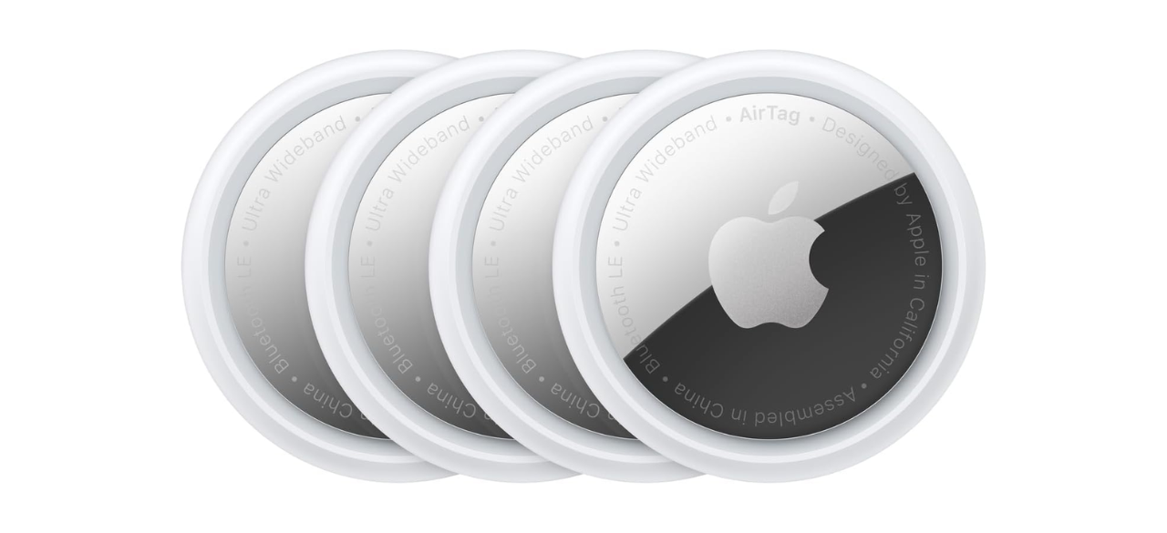 Four Apple AirTags on white background