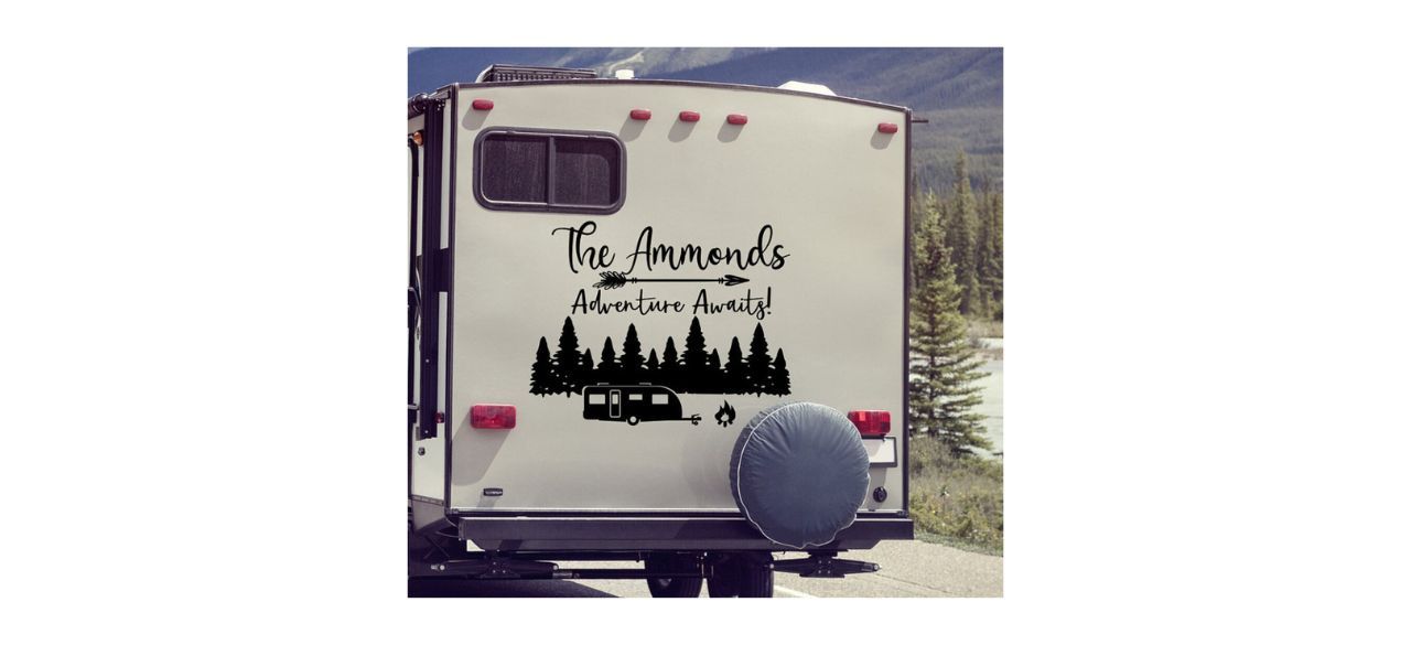 JadeDecals RV Last Name Decal with picture of RV camper in a forest and text with a family name and the words "Adventure Awaits!"