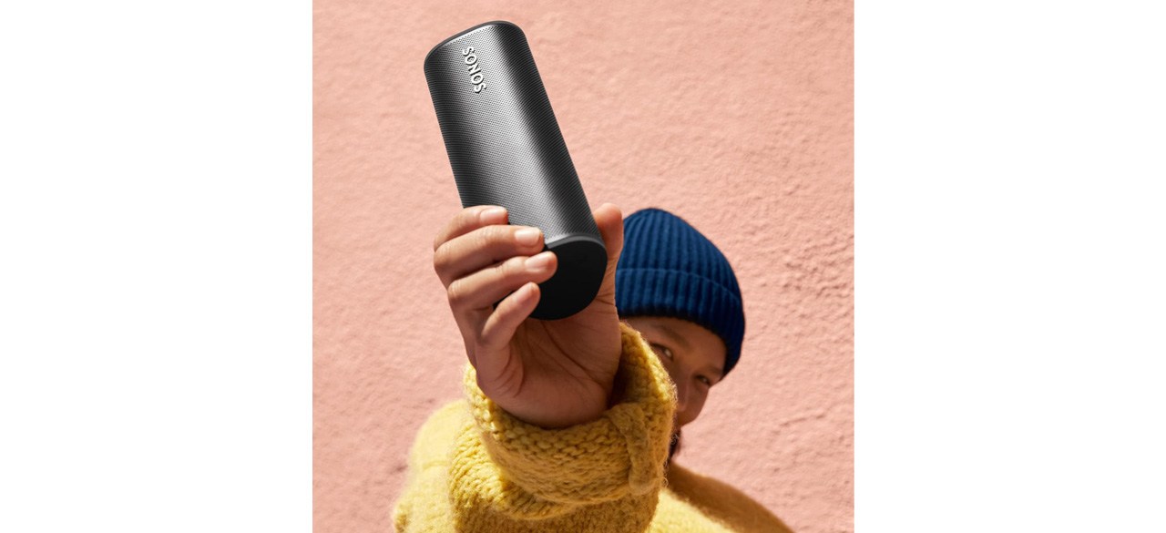 Person holding up Sonos Roam