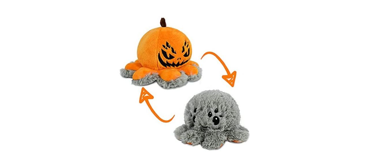 An orange pumpkin spider plushie that turns into a gray spider plushie when you turn it inside-out