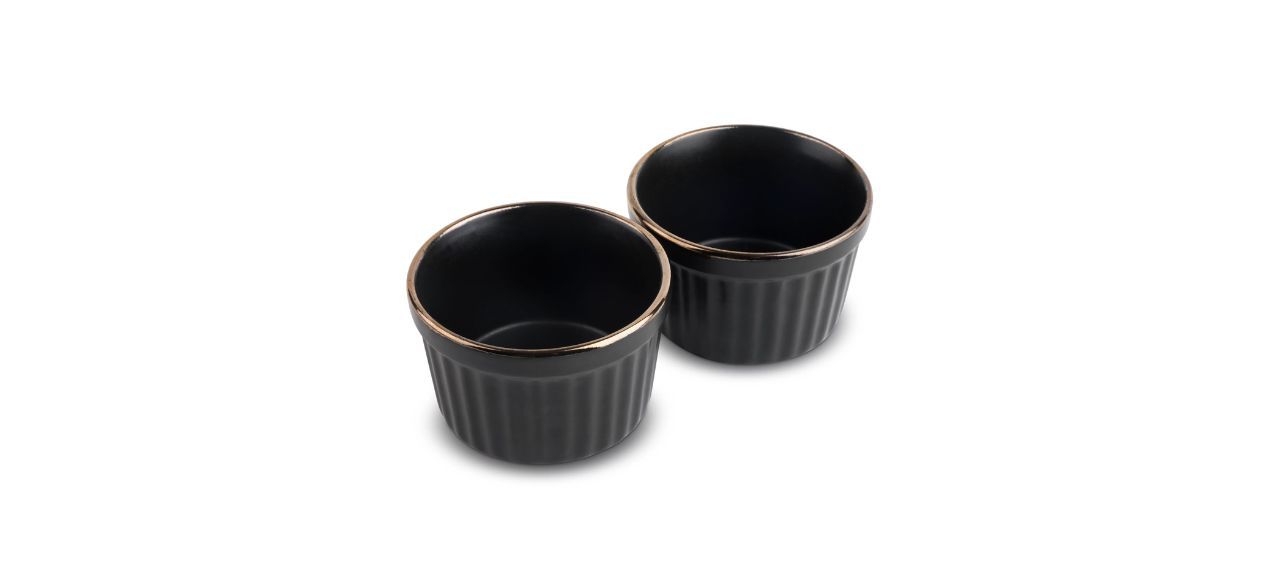 2 black stoneware ramekins with a gold finish on the top