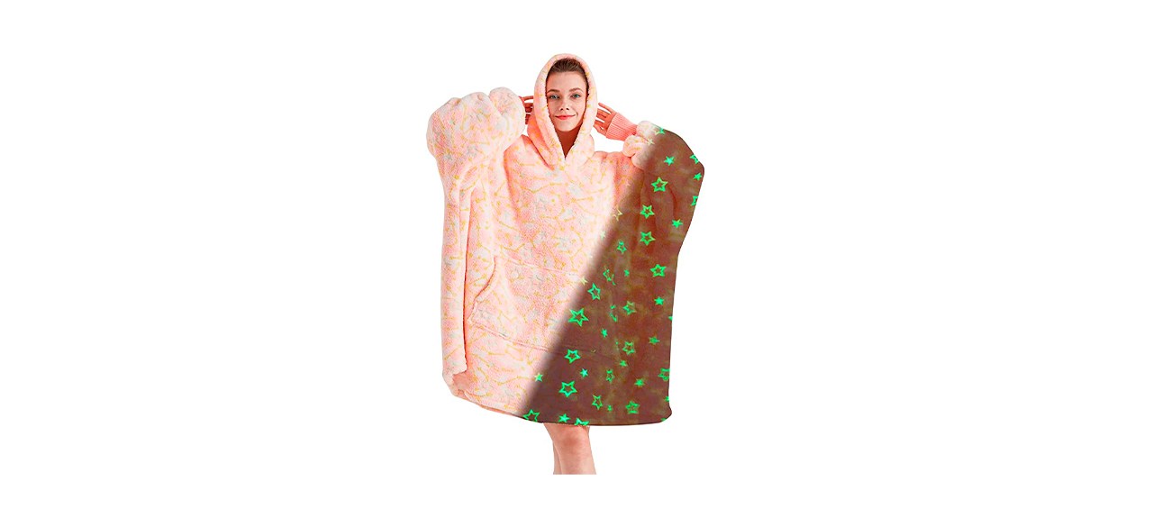 pink wearable blanket hoodie with glow-in-the-dark green stars on it