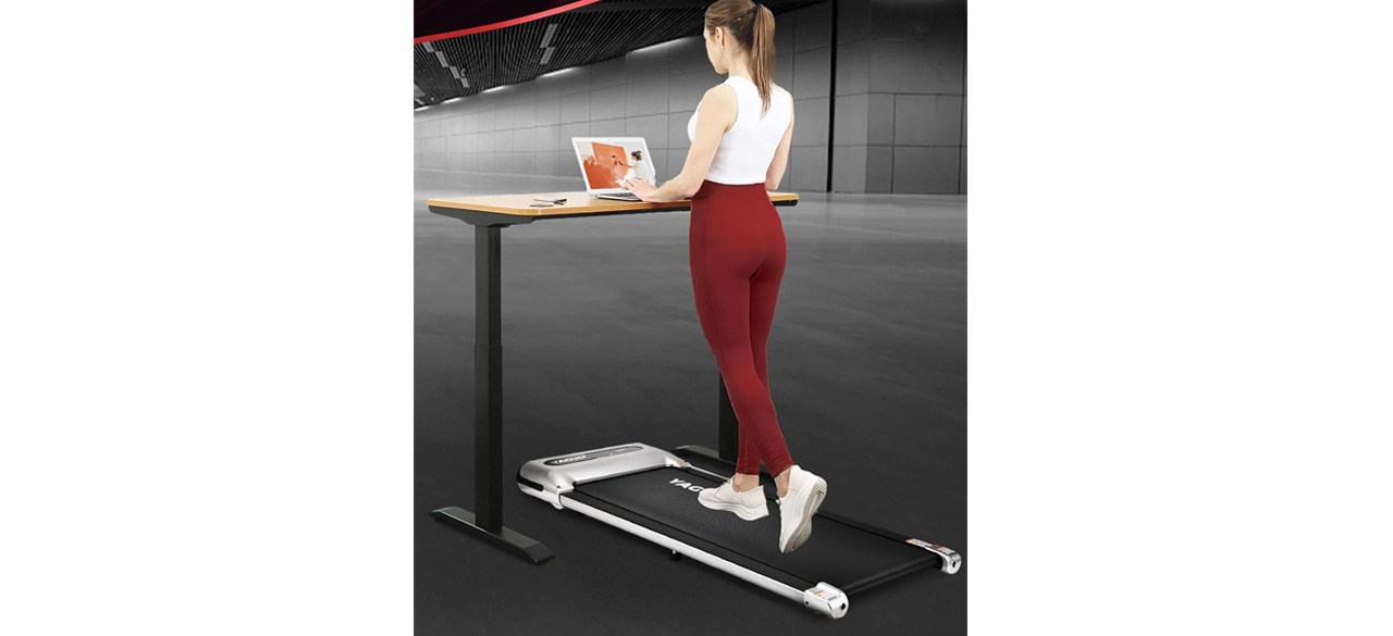 Person using Yagud Under Desk Treadmill while working at standup desk