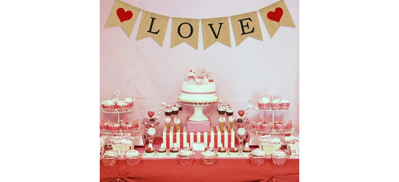 Love Burlap Banner for Valentine's Day hanging above table with cake and cupcakes