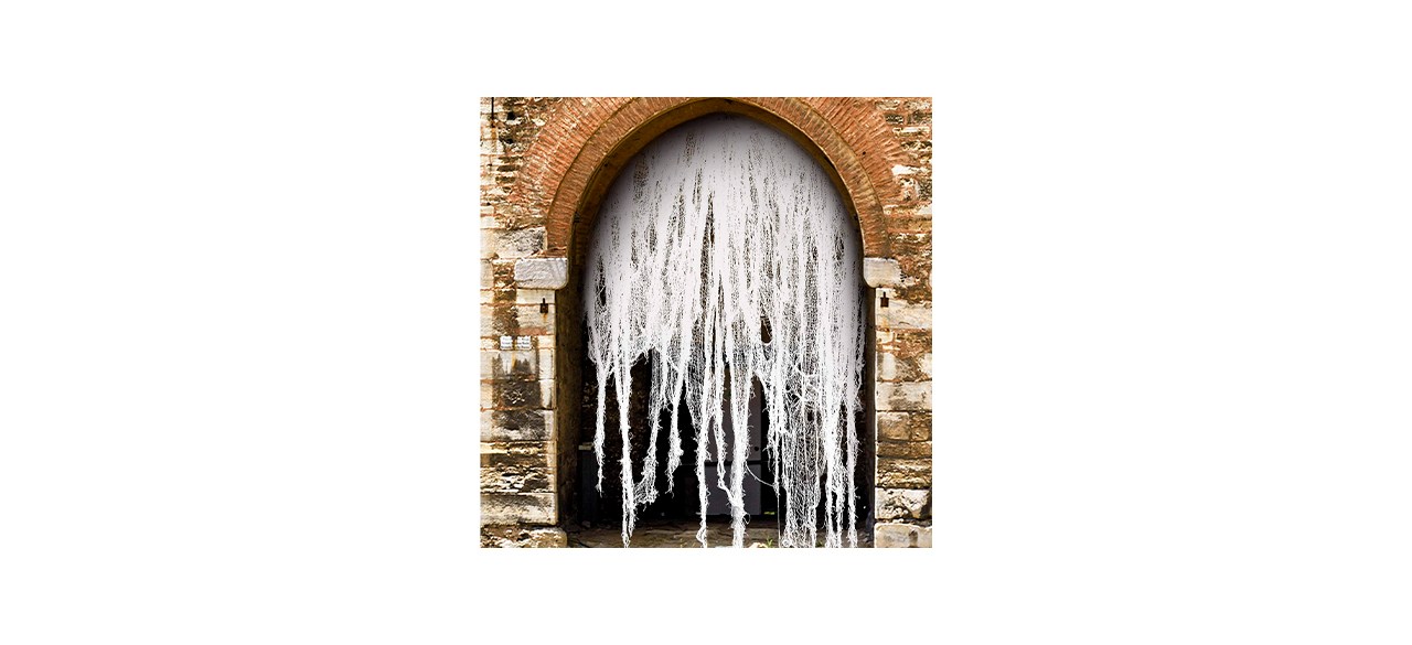 A tattered white cloth hanging from an archway